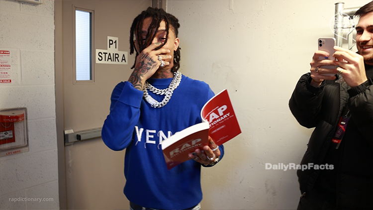 Swae Lee holding the Rap Dictionary